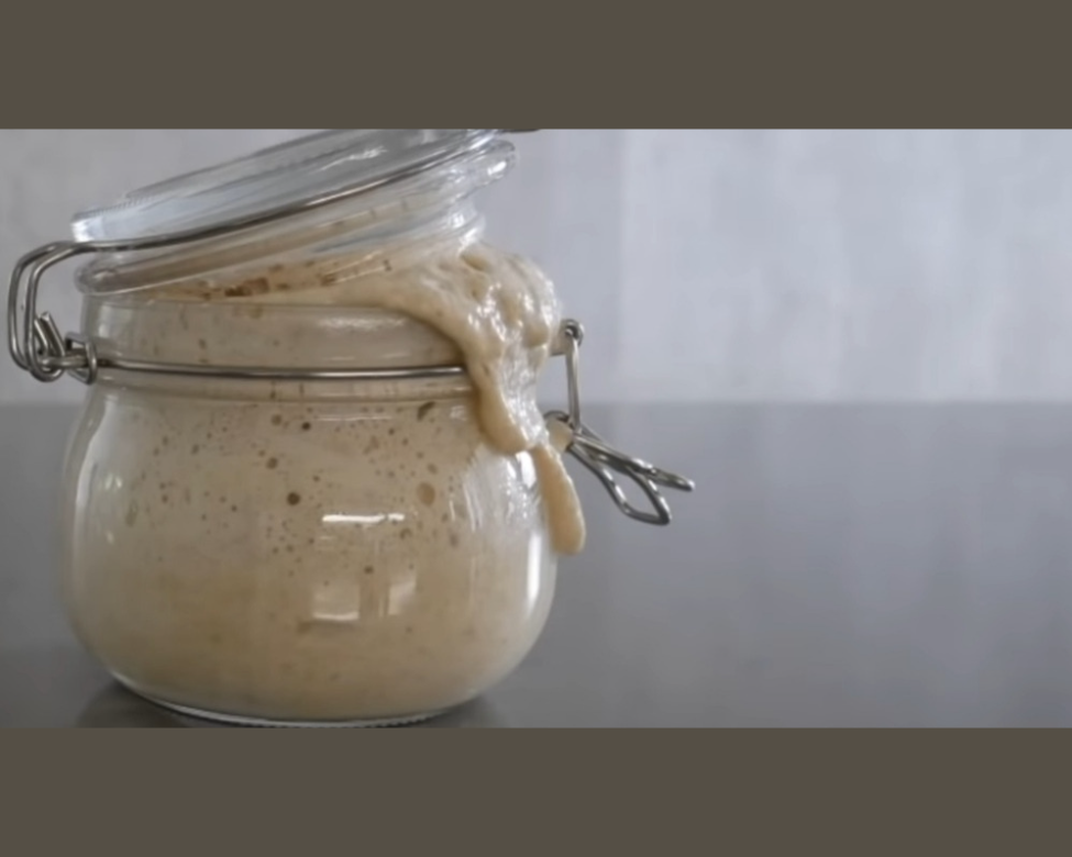 Jar with sourdough starter spilling