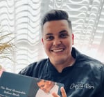 Luke Rogers with Cookbook-crop